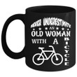 An Old Woman With A Bicycle Black Ceramic Mug