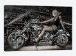 Female model with a motorcycle in a workshop