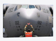 Ground Crewmember Marshals A C-17 Globemaster III To Its Parking Spot