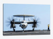 Aviation Boatswain's Mate Directs An E-2C Hawkeye On The Flight Deck