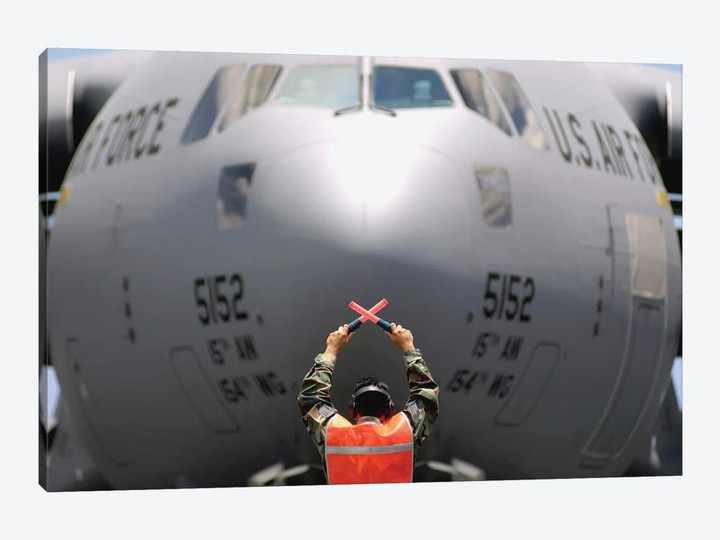 Ground Crewmember Marshals A C-17 Globemaster III To Its Parking Spot
