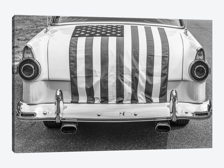 USA, Massachusetts, Essex. Antique cars, detail of 1950's-era Ford draped with US flag.