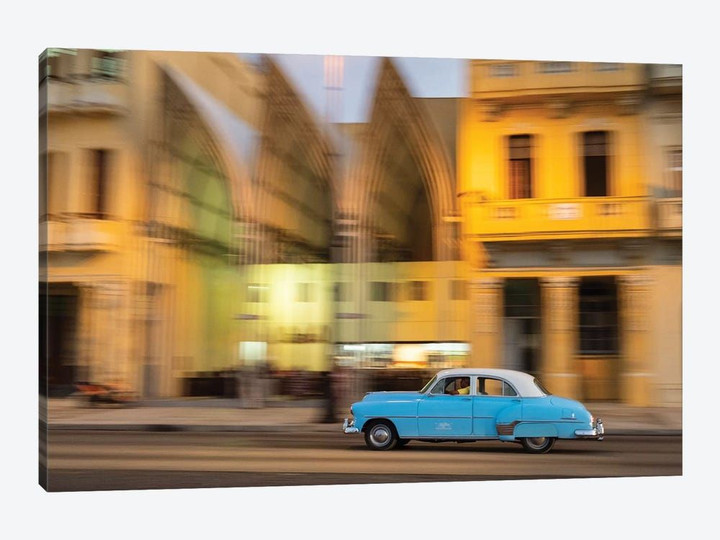 Cuba, Havana, classic car in motion at dusk on Malecon.