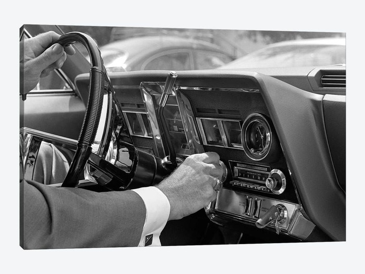 1960s Hand On Car Radio Dials And Steering Wheel