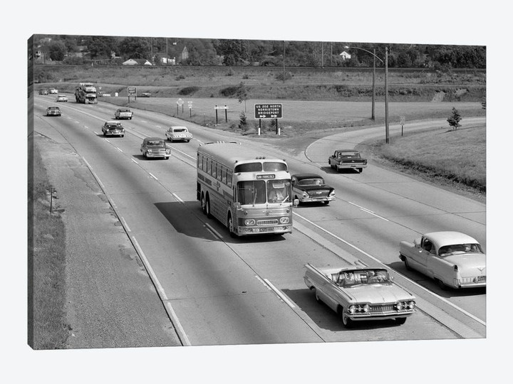 1960s Overhead Of Busy Four Lane Undivided Highway With Convertible Car And Long Haul Passenger Bus Approaching Camera