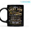 I Am A Lucky Son Because I’m Raised By A Freaking Awesome Mom If You Mess With Me She’ll Punch You In The Face Very Hard Black Coffee Mug Funny Gift For Son From Mother Son Mug Gift For Him