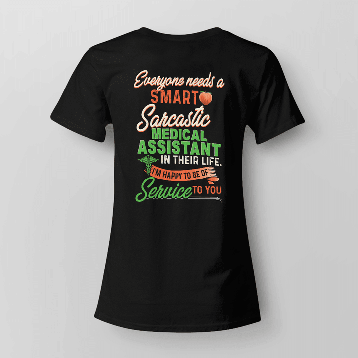 Black t-shirt with white text: Everyone needs a SMARTO - Sarcastic Medical Assistant in their life. I'm happy to be of service to you.