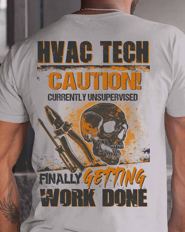 White t-shirt with black graphic design of skull and pliers, accompanied by the quote 'HVAC TECH CAUTION! CURRENTLY UNSUPERVISED FINALLY GETTING WORK DONE'.