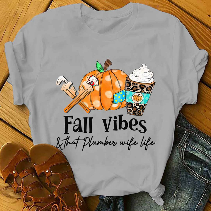 Black t-shirt with white text 'Fall Vibes & That Plumber Wife Life' - Perfect for plumbers and their wives, showcasing love for the profession and the fall season.
