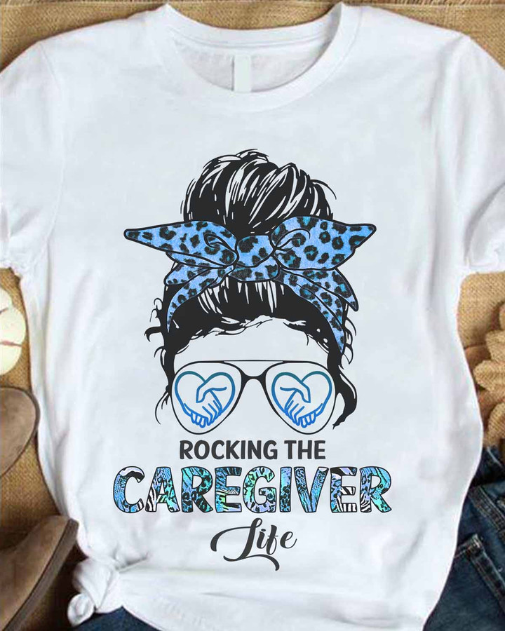 White t-shirt with blue leopard print headband and sunglasses, representing the caregiver profession.