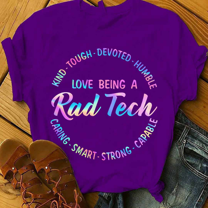 Purple t-shirt for rad techs with the quote 'DEVOTED. HUMBLE KIND. CARING-SMART-STRONG-CAPABLE-TOUGH-. LOVE BEING A Rad Tech' in bold black and white lettering.