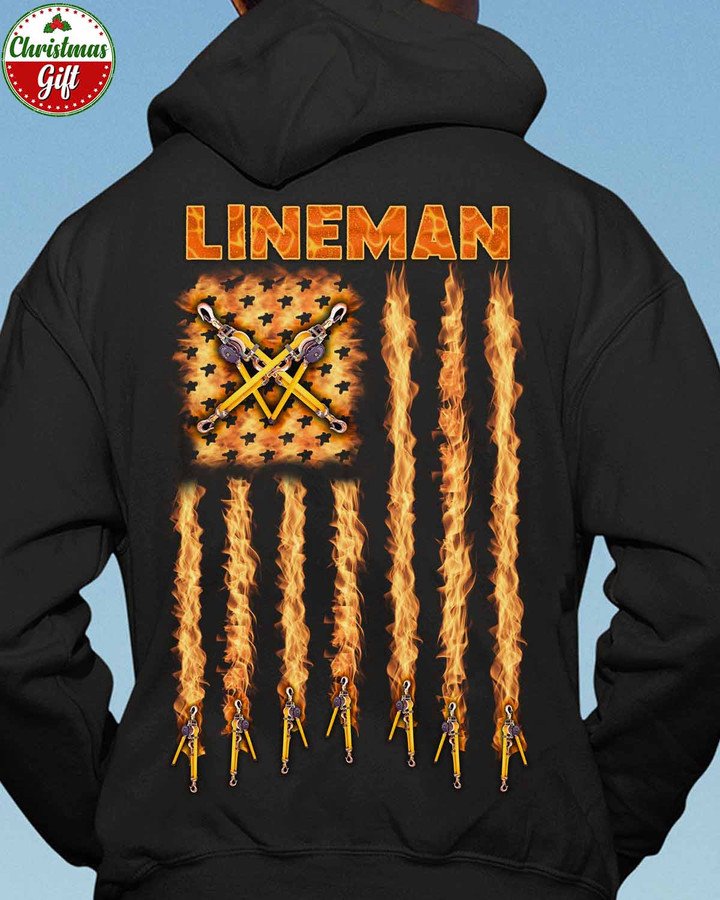 Black Lineman Hoodie with Graphic Design - Lineman holding fire hose and axe, fire flag flying in the background.