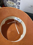 Chanel White Logo Embossed On Black Band Bucket Hat In Orange