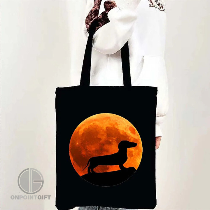 Elevate your Halloween style with our "Cute Dachshund Rainbow Moon Halloween Tote Bag." This funky and fun tote is the perfect accessory for the spooky season. Featuring an adorable Dachshund and a whimsical rainbow moon silhouette, it adds a touch of charm to your Halloween ensemble.  Made from high-quality cotton canvas, this tote is not only stylish but also practical for your shopping needs. With its spacious interior, it's great for carrying your treats, tricks, or everyday essentials. The durable construction ensures that this tote will be your go-to bag for many Halloweens to come.  Show off your love for Dachshunds and embrace the Halloween spirit with this eye-catching and unique bag. Whether you're shopping for pumpkins, heading to a costume party, or just enjoying the season, our "Cute Dachshund Rainbow Moon Halloween Tote Bag" is the ideal companion. Get yours today and celebrate Halloween in style!