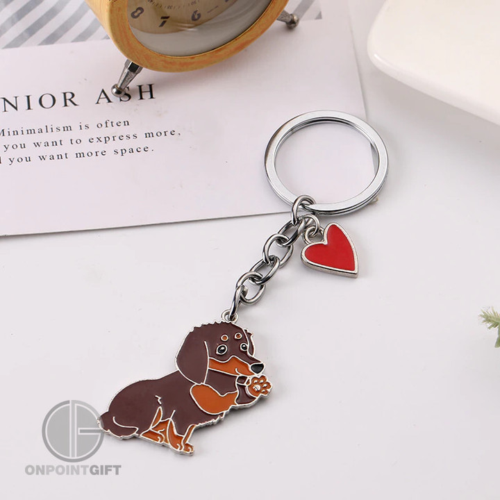Elevate your keychain game with our Cute Animal Key Ring Charms designed especially for pet lovers. These charming keychains add a touch of whimsy to your everyday essentials, making them the perfect companions for your keys, bags, or even as unique souvenirs.  Greet the Dachshund in style with our adorable Dachshund-themed keychain charm. Crafted with precision and attention to detail, it's a delightful addition to your collection. Show off your love for these lovable dogs and share your passion for pets wherever you go.  These keyring charms are not only cute and fashionable but also functional, keeping your keys organized and easy to find. Whether you're a dog or cat lover, these accessories are a perfect way to express your adoration for your furry friends.  Treat yourself or surprise a fellow pet lover with these charming key ring charms. They make wonderful gifts that celebrate the bond between humans and their four-legged companions. Add a dash of style and personality to your daily routine with these adorable animal-themed keychain charms and carry your favorite pets with you, no matter where your day takes you.