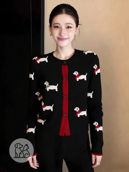 A woman modeling a black women's button-down knitted cardigan featuring a white dachshund dog pattern, long sleeves, and a red front accent trim.