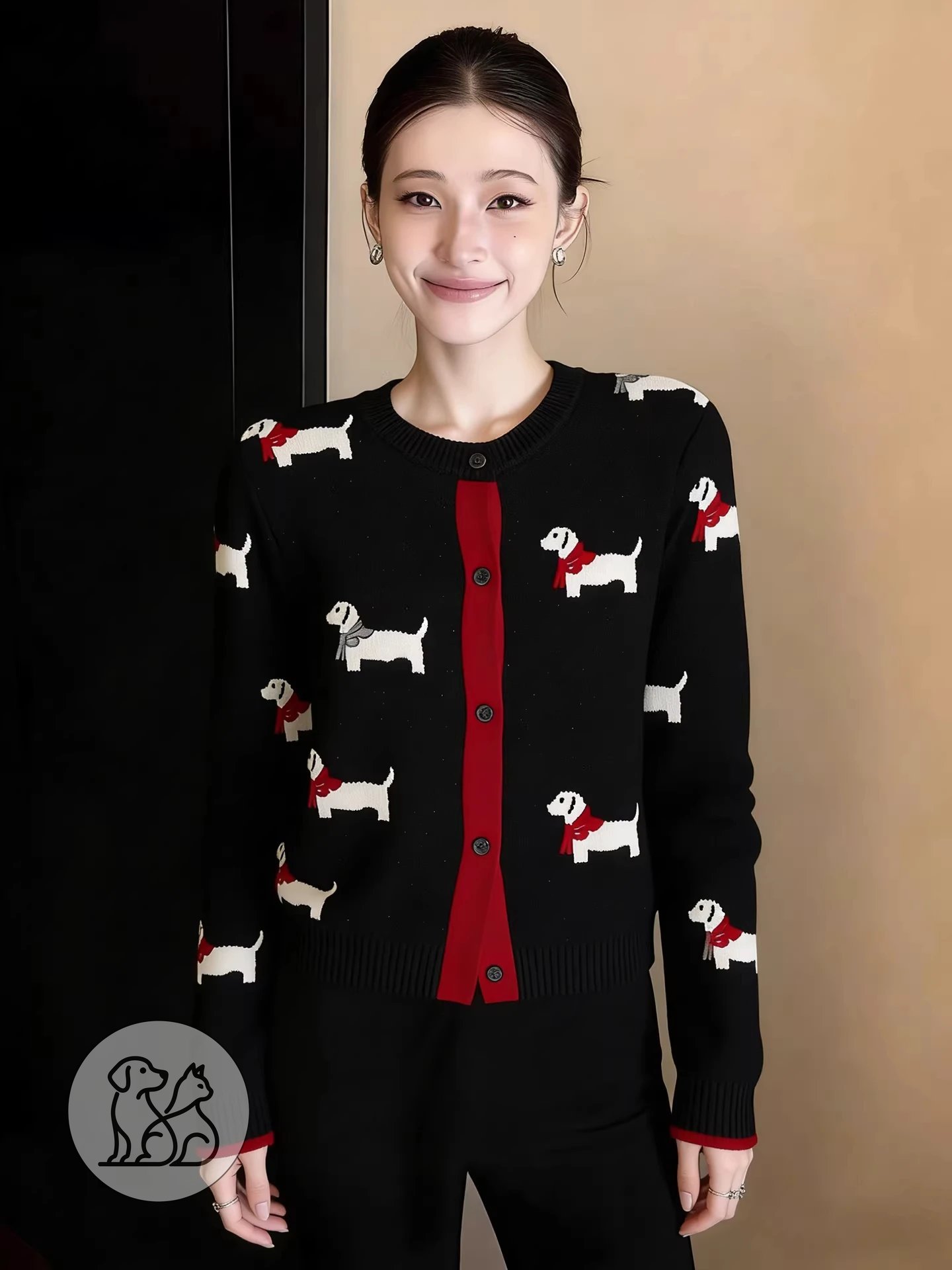 A woman modeling a black women's button-down knitted cardigan featuring a white dachshund dog pattern, long sleeves, and a red front accent trim.