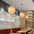 This picture shows three modern rattan pink wood color hanging lamp in the restaurant.