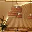 This picture shows four Southeast Asian rattan woven vintage pendant lamp in the bar.
