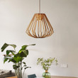 This picture shows a simple wooden cone shape wood pendant lamp in the dining room.