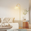 This picture shows a vintage simple rattan led floor lamp near the sofa.