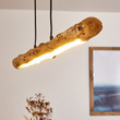 This picture shows a minimalist wood adjustable linear warm hanging lamp in the dining room.