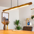 This picture shows a minimalist wood adjustable linear warm hanging lamp in the home office.