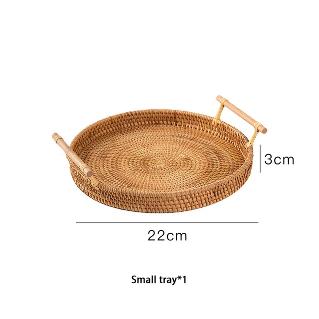 This picture shows a round handwoven rattan storage tray with wooden handle in size 22cm.