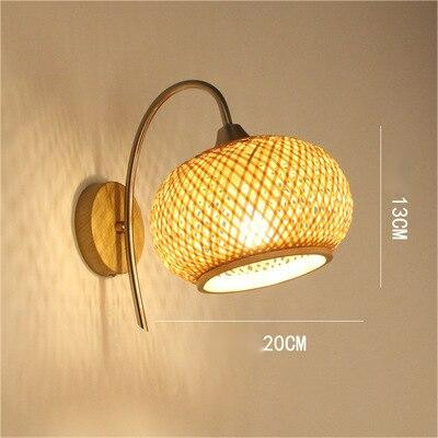 This picture shows a woven bamboo wall lamp in size 20cm