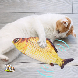 A white cat playing with an interactive electric floppy fish toy.