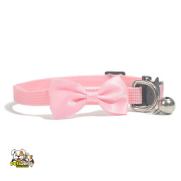 Adorable dog wearing an adjustable pet collar with a bow bell.