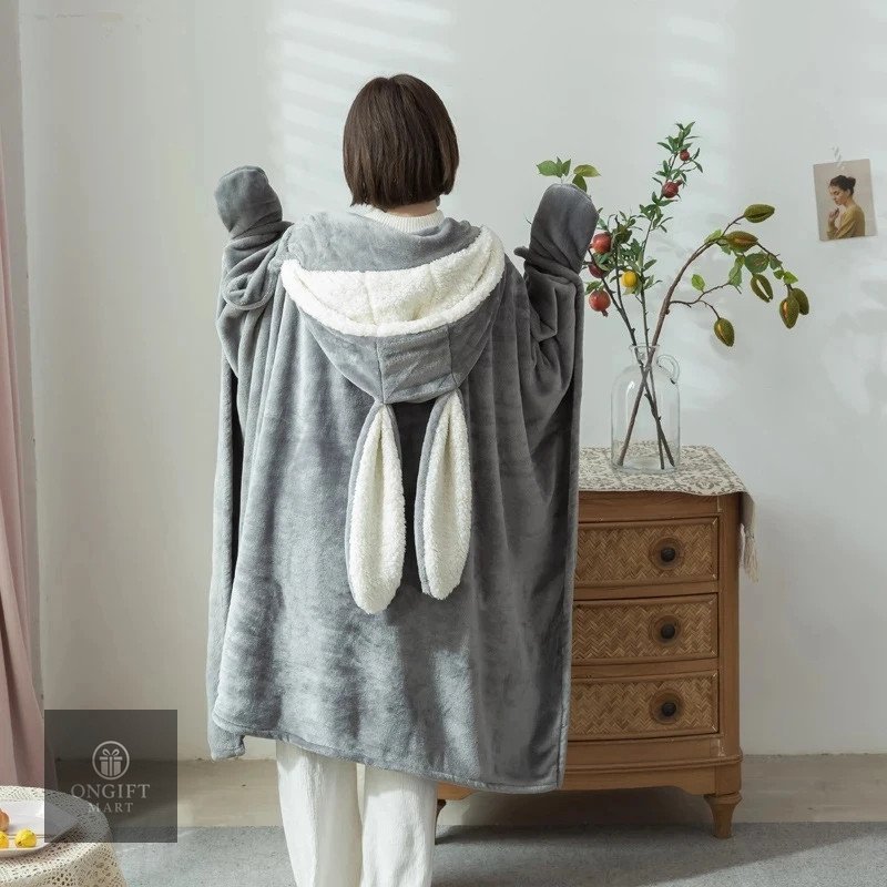 Stay warm and cozy with this Kawaii Wearable Rabbit Blanket! Made with soft coral velvet, this cute Japanese-style hooded throw is perfect for adults and kids. A lovely winter essential and adorable gift for rabbit lovers.