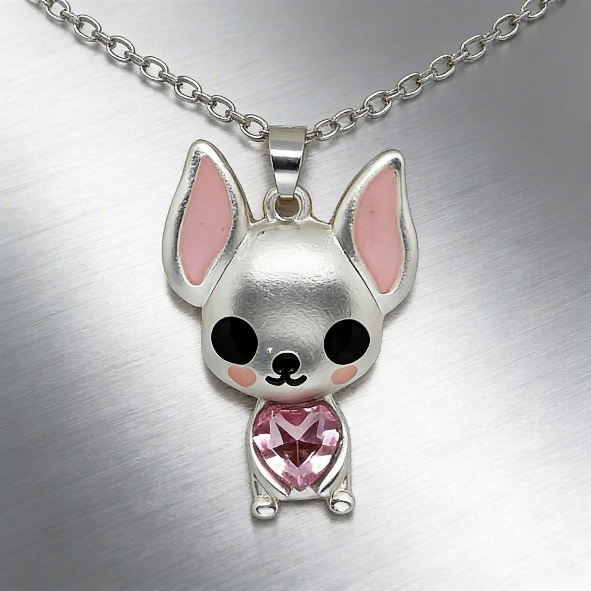 Silver-tone Chihuahua necklace with a large pink heart-shaped crystal pendant