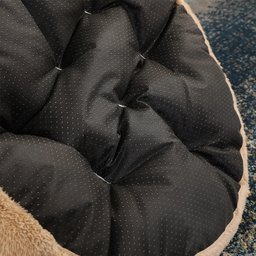 Close-up of soft dark cushion inside plush dog sofa bed