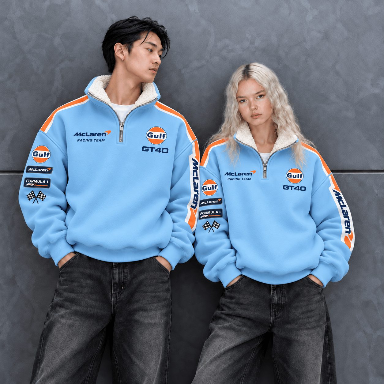 Two models wearing sky-blue racing quarter-zip pullovers with white sherpa collars