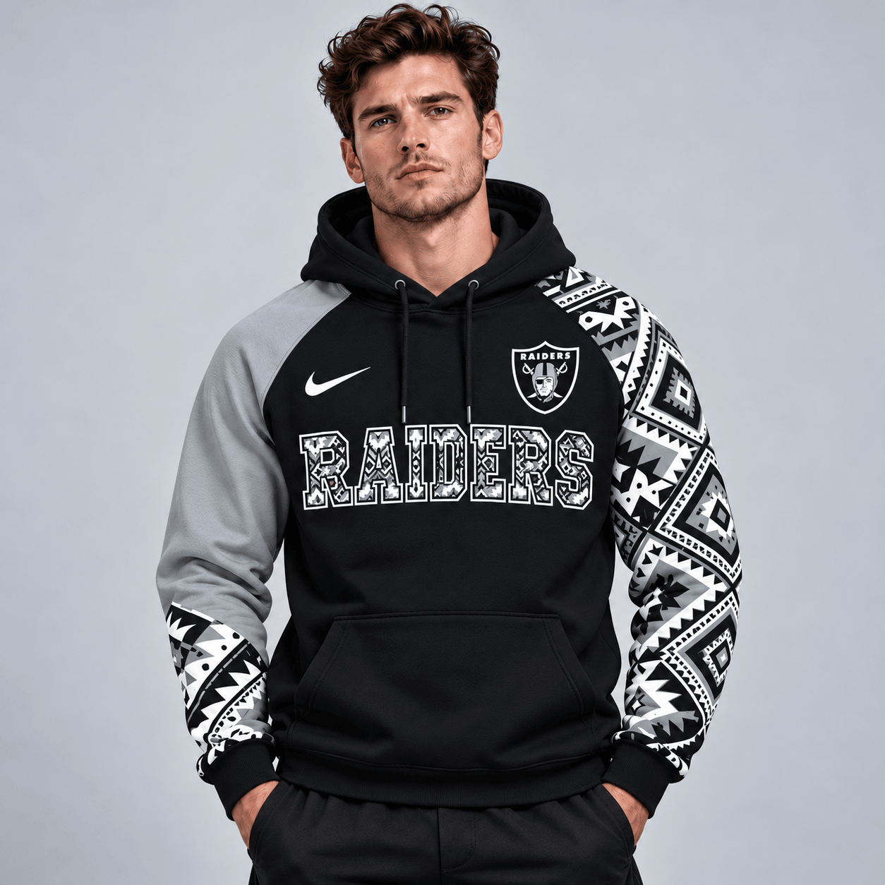 Las Vegas Raiders | Premium NFL Aztec Inspired Colorblock Pullover Hoodie With Asymmetric Sleeves And Bold Team Lettering NDN cover
