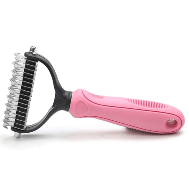 2-Sided Deshedding Undercoat Rake for Golden Retrievers - pink-handled rake lying on its side showing the dual-sided teeth