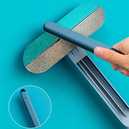 4-in-1 pet hair remover brush for Golden Retrievers – close-up of the brush head and flannel surface on a teal background
