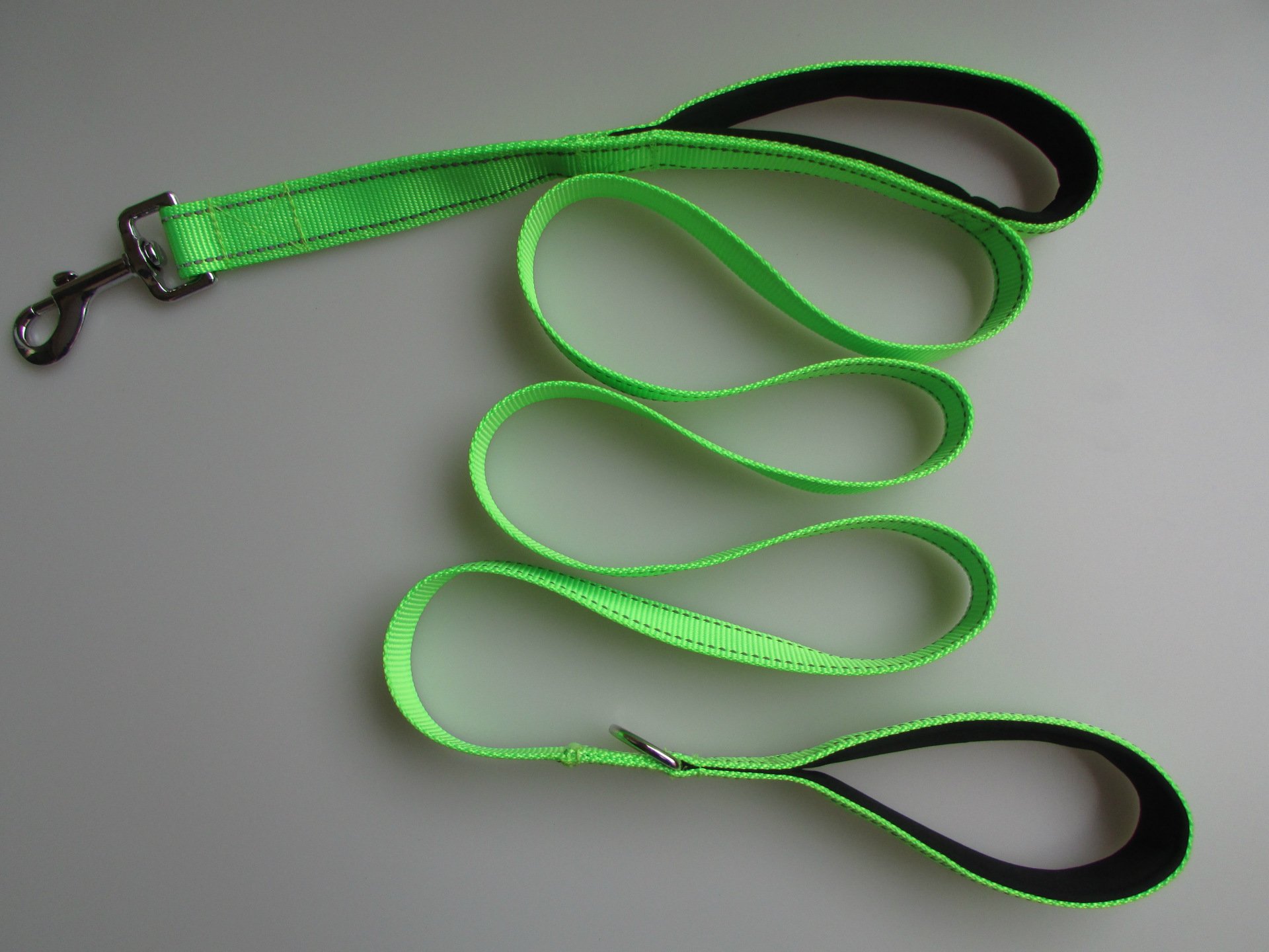 Double handle training leash for Golden Retrievers — bright green leash with black-trimmed padded handles and metal clasp, laid out in loops