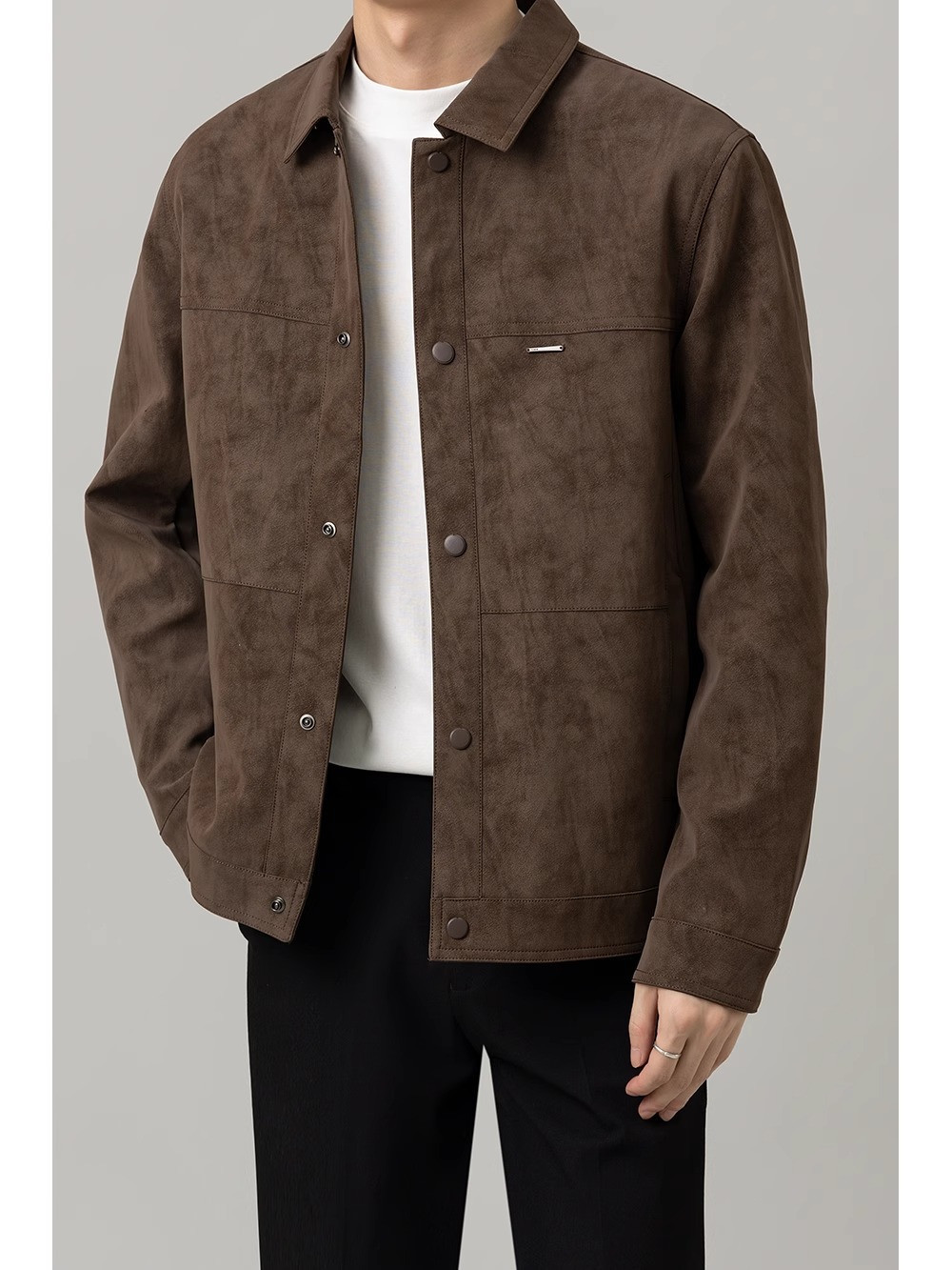 Male model wearing QADIM brown suede jacket open over a white T-shirt