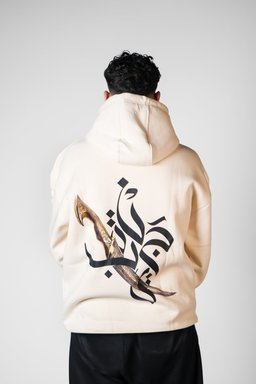 Jambiya hoodie in beige worn by a model – jambiya dagger with Arabic calligraphy print by QADIM