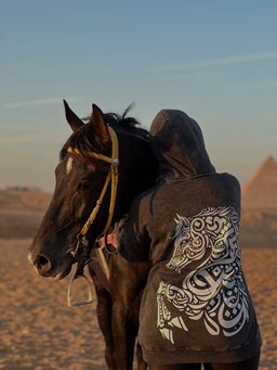 Asil hoodie styled in Egypt – Arabian horse in Arabic calligraphy on the back (QADIM washed-black edition)