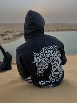 Asil hoodie styled in Egypt – Arabian horse in Arabic calligraphy on the back (QADIM washed-black edition)