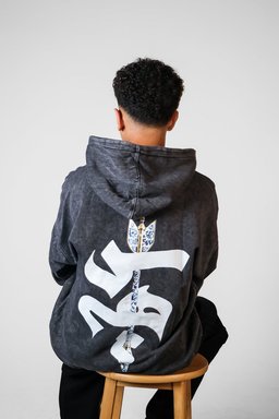 Sahm hoodie styled in Egypt – arrow in Arabic calligraphy on the back (QADIM washed-black edition)