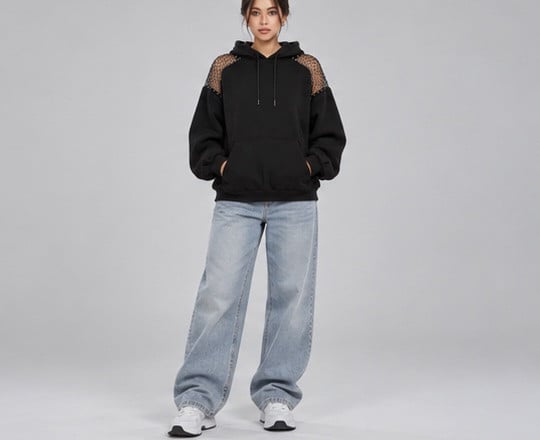 Model facing the camera in the black hoodie; the front is plain