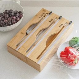 Top view of bamboo kitchen organizer with plastic wrap and foil compartments