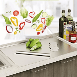 Fresh vegetables and fruits chopped on stainless steel cutting board