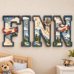 May include: A set of four layered wooden letters spelling FINN, featuring a blue border and a multi-layered interior design. The letters depict a scene with red airplanes, white clouds, green pine trees, snow-capped mountains, and a compass.