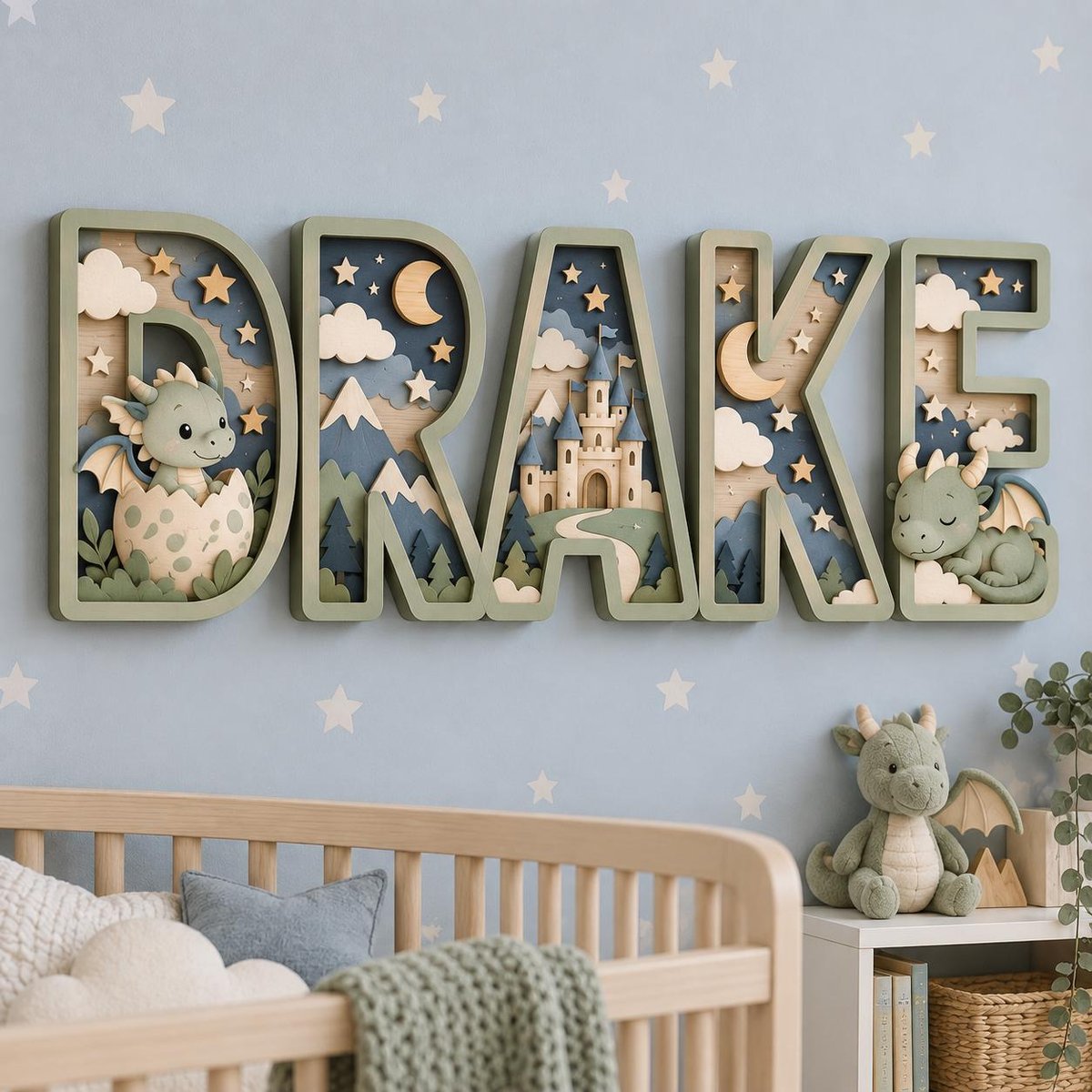 May include: A multi-layered wooden wall sign spelling the name DRAKE in sage green block letters. Each letter contains a 3D scene featuring a light green dragon, a beige castle, mountains, pine trees, clouds, stars, and a crescent moon.