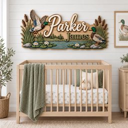 May include: A wooden wall sign featuring the name Parker James in script and block lettering, decorated with two mallard ducks, cattails, water lilies, and a pond scene. The sign is mounted on a white shiplap wall above a wooden baby crib.